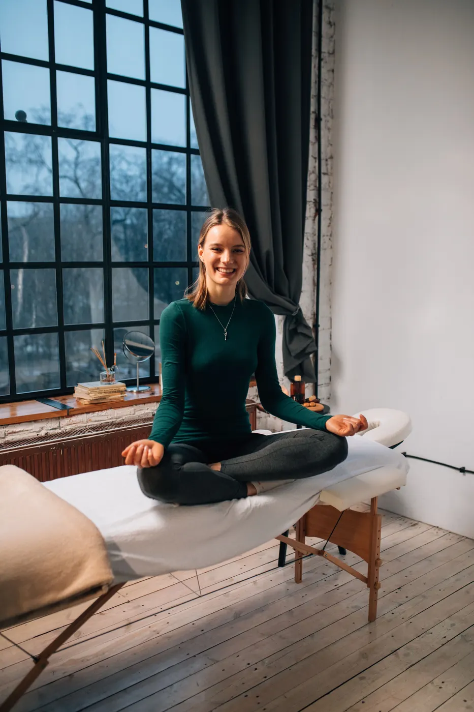 Woman meditating in a calm, naturally lit wellness setting